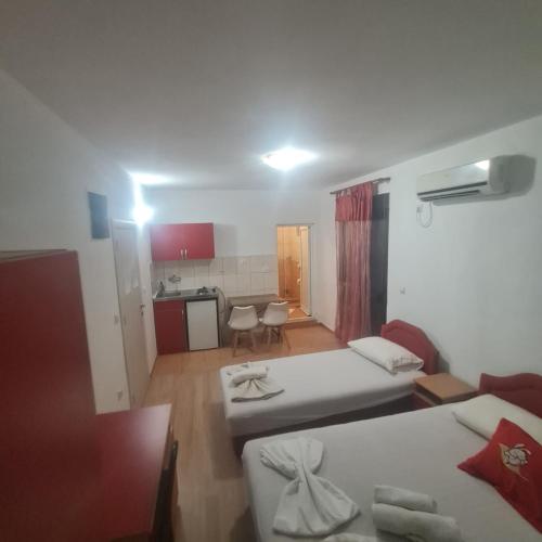 a living room with two beds and a kitchen at Apartmani Moco in Ulcinj
