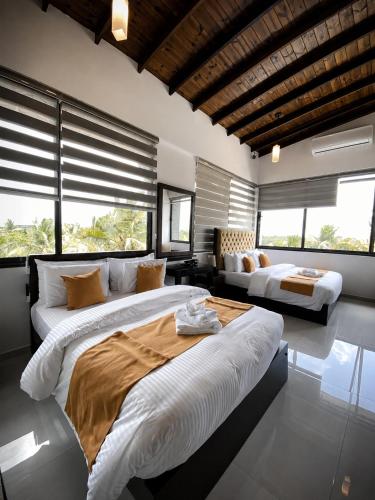 a large bedroom with two beds and a couch at Dhanora Dynasty Resort in Anuradhapura