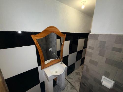 a bathroom with a sink and a mirror at Kwarto's in Siquijor