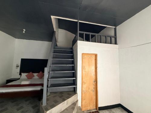 a room with a bunk bed and a staircase at Kwarto's in Siquijor
