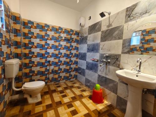a bathroom with a toilet and a sink at ICONIC Hotel Digha in Digha