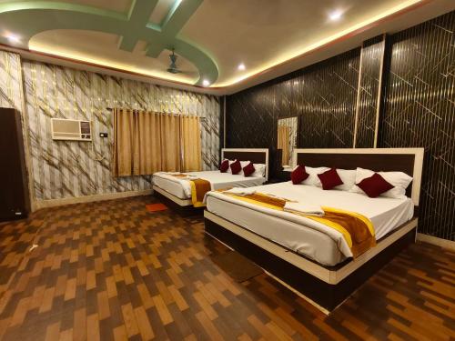 a bedroom with two beds in a room at ICONIC Hotel Digha in Digha