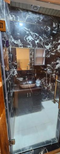 a bathroom with a counter and a sink in a room at The Eros in Sonīpat