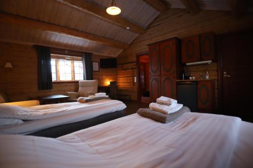 a room with two beds in a wooden room at Tunet in Hemavan