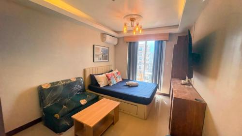 a small living room with a couch and a table at 1403-304 Saekyung Pool view in Lapu Lapu City