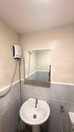 a bathroom with a sink and a mirror at 1403-304 Saekyung Pool view in Lapu Lapu City