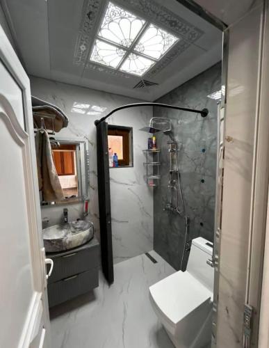a bathroom with a shower and a toilet and a sink at Yusubovs in Hacıkǝnd
