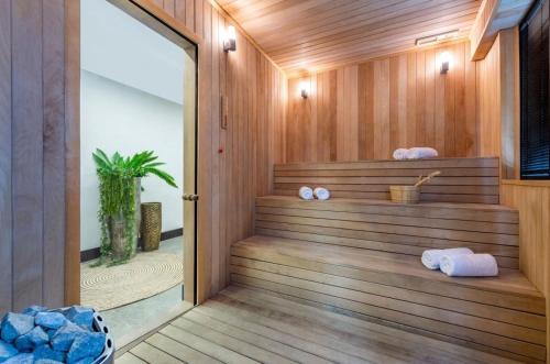 a sauna with wooden walls and a wooden floor at Nova Concierge Aparthotel in Batumi