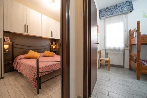 a bedroom with a bed with orange pillows on it at CASE VACANZE ROSA CON SERVIZIO SPIAGGIA in Lido Adriano