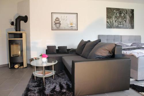 a living room with a couch and a bed at Landluft in Gnissau