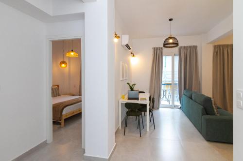 a living room with a couch a table and a bed at The Minimal Apartments 3Floors in Loutra Edipsou