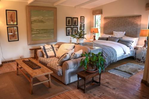 a bedroom with a bed and a couch at The Dogbox, Karen in Nairobi