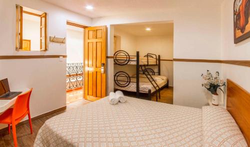a bedroom with a bed and a bunk bed at Hotel Templo Mayor in Mexico City