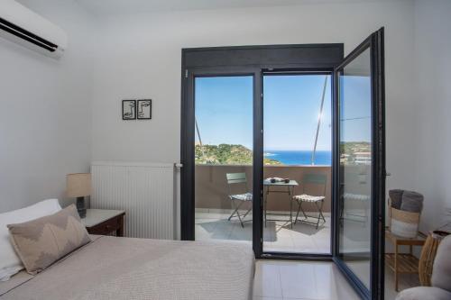 a bedroom with a bed and a view of the ocean at Sea View Apartment in Rhodes Town