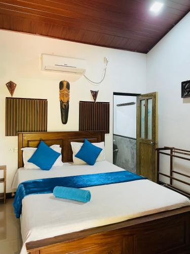 a bedroom with a bed with a mask on the wall at Angry birds rooms in Habarana