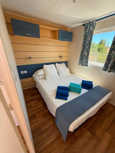 a bedroom with a large bed with blue pillows on it at La Finquilla Holidays in Estepona