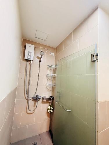 a shower with a glass door in a bathroom at JFam Suites, C3-9D Studio, Up To 4 Pax in Biñan