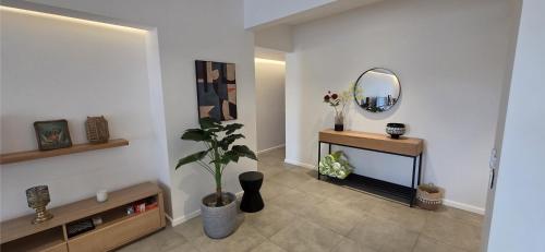 a living room with a mirror and a potted plant at Holiday - Comfort - Spacious - Escape in Grand-Baie