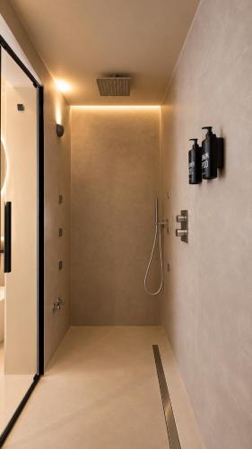 a bathroom with a shower in a room at Naim Boutique Hotel in Costa Rei