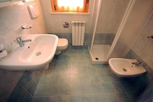 a bathroom with a sink and a toilet and a shower at Residence Seaside in Tortoreto Lido