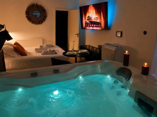 a large bath tub in a room with a bed at Le Rêve de Stanislas - Jacuzzi Nancy centre in Nancy