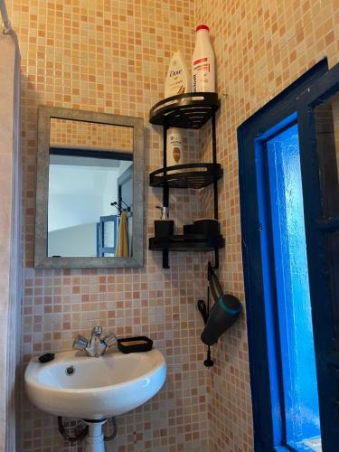 a bathroom with a sink and a mirror at Casa María in Asilah