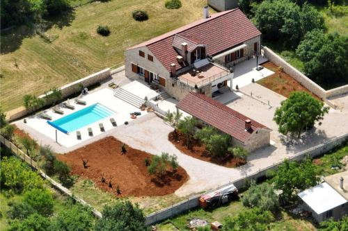 an aerial view of a house with a swimming pool at Villa Demare with Heated Pool, Free EVC Station in Lovinac