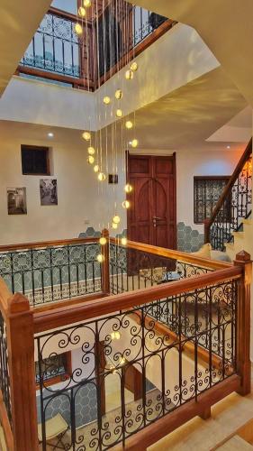 a room with a staircase with a chandelier at Dar Al Massir in Chefchaouen