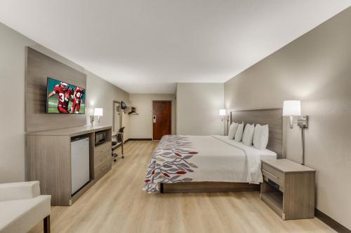 a large hotel room with a bed and a desk at Red Roof Inn & Suites Newport - Middletown, RI in Middletown