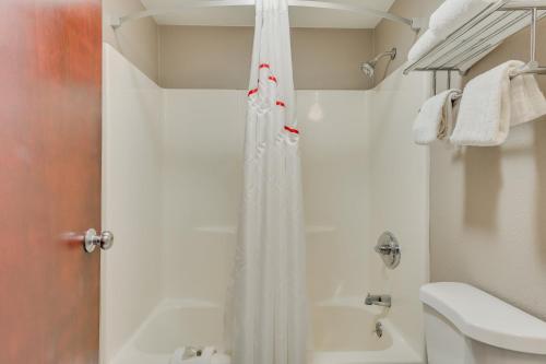 a bathroom with a shower and a toilet and a sink at Red Roof Inn & Suites Newport - Middletown, RI in Middletown
