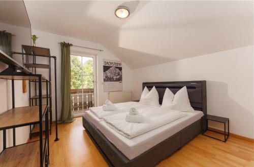 a bedroom with a large bed with two ducks on it at Bergvilla-Ramsau in Ramsau am Dachstein
