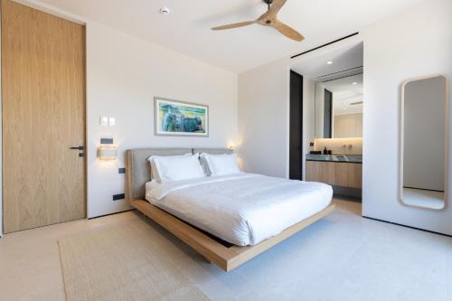 a bedroom with a large bed with a ceiling fan at Villa Kairos in Foiníki