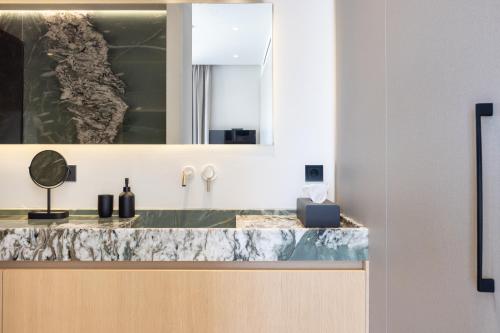 a bathroom with a marble counter top and a sink at Villa Kairos in Foiníki