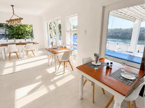 a dining room with a table and a view of the ocean at Blues at Bonza Bay Beach in Beacon Bay