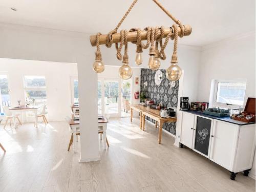 a kitchen and dining room with a chandelier at Blues at Bonza Bay Beach in Beacon Bay
