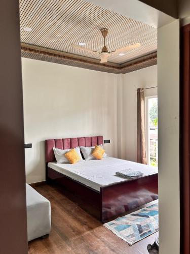 a bedroom with a large bed in a room at Rodali stay in Dibrugarh