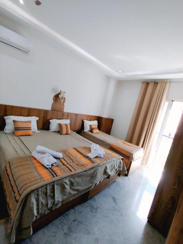 a bedroom with two beds with towels on them at Hôtel Dar Farhat in Tunis