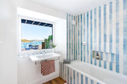 a bathroom with a sink and a window at Panoramic harbour views Morva in Falmouth