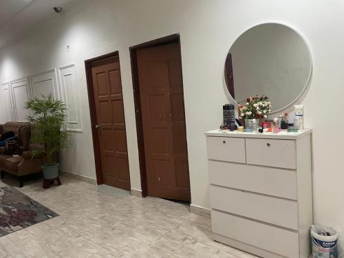 a room with a dresser with a mirror on it at Villa Cempaka II in Changlun