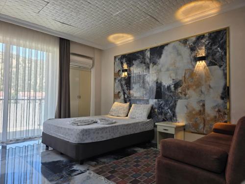 a bedroom with a bed and a couch at Haciely Thermal Otel in Denizli