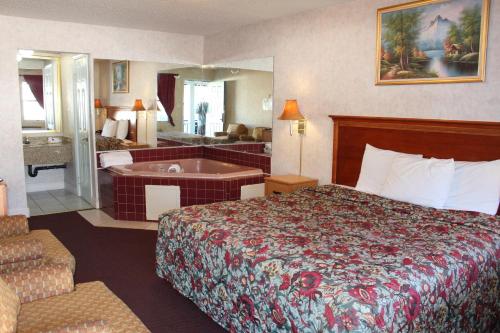 A bed or beds in a room at Highlander Motor Inn Atlantic City