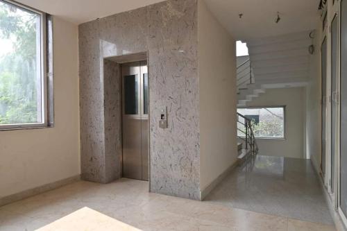 a hallway of a house with a stone wall at Iskcon guest house in Patna