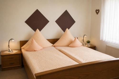 a bedroom with two beds with pillows on them at Gästehaus Stillecke in Erwitte
