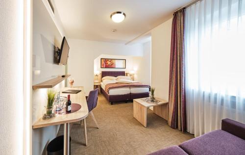 a hotel room with a bed and a couch at Hotel zum Adler - Superior in Bonn