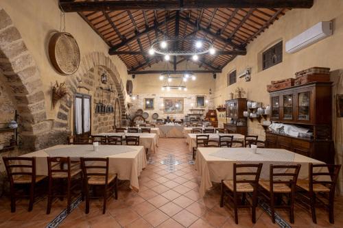 a restaurant with tables and chairs in a room at Agriturismo Duca di Castelmonte in Trapani