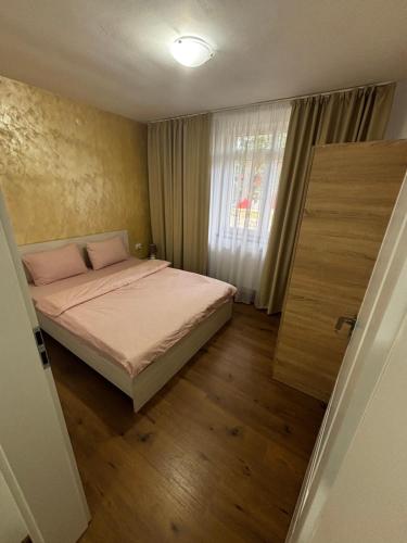 a small bedroom with a bed and a window at Signature Studio Arad in Arad