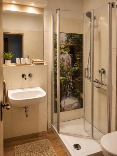 a bathroom with a sink and a shower at Gästehaus Stillecke in Erwitte