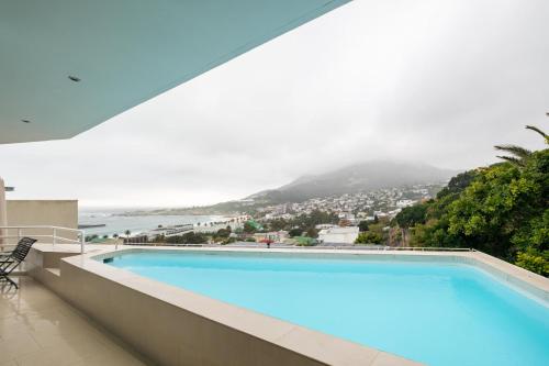 a swimming pool with a view of the ocean at Silvertree in Cape Town