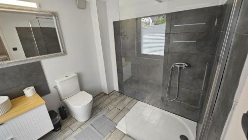 a bathroom with a shower and a toilet at Gościnny Dom Kaola in Rewal