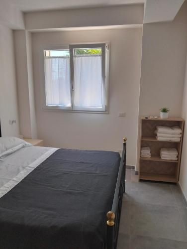 a bedroom with a bed and a window at La Casa di Mami in Velletri